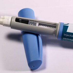 Home Detailed view of a semaglutide injection pen, commonly used for diabetes treatment, on a plain background.