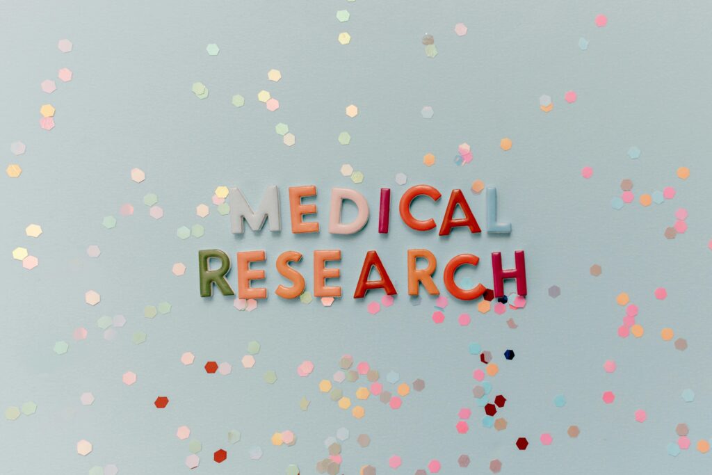 Home Colorful letters spell "Medical Research" against a confetti-strewn backdrop.